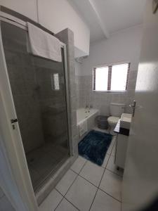 a bathroom with a shower and a toilet and a tub at Villa Del Sol Unit 2 in Margate