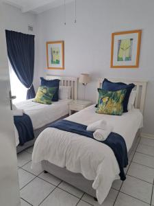 a bedroom with two beds with blue and white at Villa Del Sol Unit 2 in Margate
