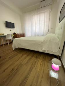 a bedroom with a bed and a table and a desk at 2 Passi Da in Rome