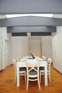 a white table and chairs in a room at Rooftop Regensburg in Regensburg