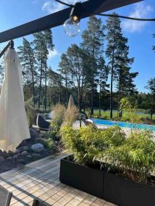 a patio with an umbrella and a swimming pool at Beautiful Villa by the sea in Porvoo
