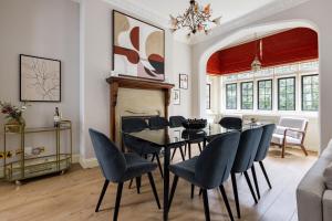 a dining room with a table and chairs at The Woking Wonder - Captivating 3BDR Flat with Parking in Woking
