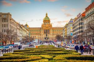 a large building with a clock tower in a city at Finnem Rentals Varnsdorfská in Prague