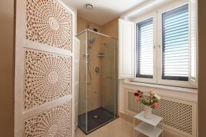 a bathroom with a shower with a glass door at Corvaja Inn in Taormina
