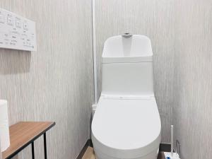 a bathroom with a white toilet in a room at The Kojima in Tokyo