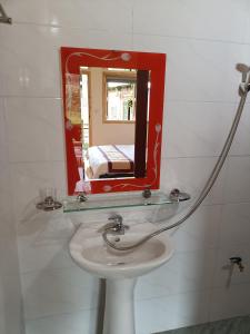 a bathroom with a sink and a mirror at Moc's House in Bắc Hà