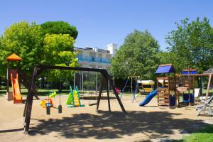 a playground with colorful playground equipment in a park at Hotel Hiki 3 Superior in Bibione