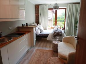 a small kitchen with a bed in a room at Urocze Studio 7 z parkingiem in Katowice