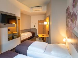 Postel nebo postele na pokoji v ubytování B&B Hotel Hildesheim