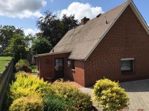 a small brick house with a roof at Haus Ahkamp in Hemmoor