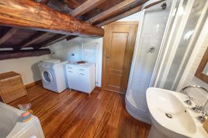 a bathroom with a sink and a washing machine at Mansarda Portofino in Portofino