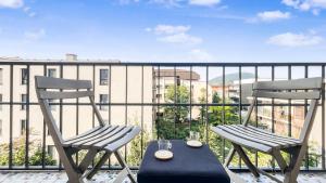 two chairs and a table on a balcony at COLOC CAPUCIN - Belle colocation avec 3 chambres indépendantes / Balcon privé / Parking collectif / Wifi gratuit in Annemasse