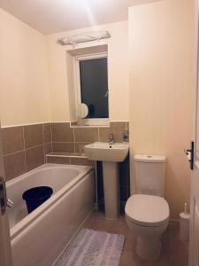 a bathroom with a sink and a toilet and a bath tub at Stunning 3 bed home at the heart of Wolverhampton in Wolverhampton