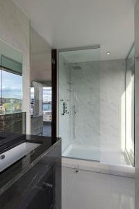a bathroom with a glass shower and a sink at Doubletree By Hilton London - Greenwich in London