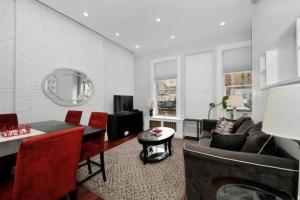a living room with a couch and a table at Spacious 1 BR close to Central Park in New York