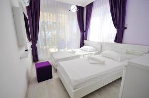 A bed or beds in a room at Fuda Hotel