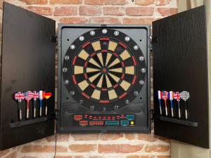 a dart board on a brick wall with darts at L'Étage, hypercentre Toulousain, Climatisé in Toulouse