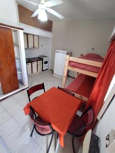 a kitchen with a table and a bunk bed at Santa Teresita Apartments by San Remo in Santa Teresita +8 photos