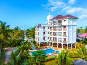an aerial view of a hotel with a pool and palm trees at Zanoceanique Hotel in Matemwe