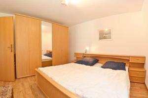 a bedroom with a large bed and a mirror at Feriendorf Reichenbach - Bgm.-Martin-Str. 10/1 in Nesselwang +28 photos