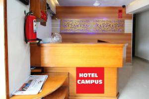 a hotel lobby with a hotel campus sign on a desk at HOTEL CAMPUS in Ahmedabad