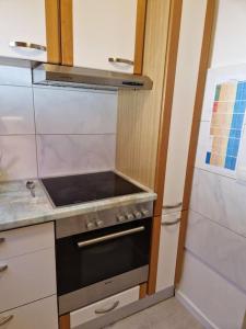 a kitchen with a stove and a stove top oven at Stilvoll und gemütlich in Bellheim +5 photos