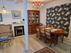a dining room with a table and a fireplace at Stilvoll und gemütlich in Bellheim