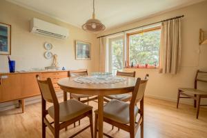 een keuken en eetkamer met een tafel en stoelen bij Charming 2-bedroom home - 20min walk to city centre in Tórshavn