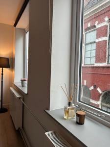 a room with a window with a table and a lamp at Annalisa Guest House Centrum in Enschede