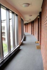an empty hallway of a building with windows at 2 bed flat near Milton Keynes city centre in Milton Keynes