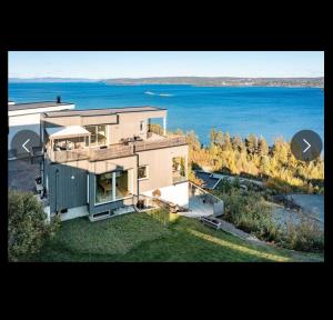 a large house with a view of the water at Moderne funkis med fantastisk havutsikt in Asker