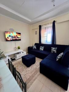 a living room with a couch and a table at Exquisite Modern suite 1bedroom in Busia