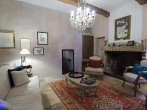 a living room with a couch and a fireplace at Luxurious Provencal Village House, Walk to Village Pool in Rustrel