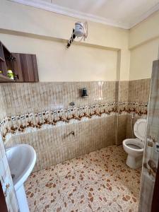 a bathroom with a toilet and a sink at Exquisite Modern suite 1bedroom in Busia