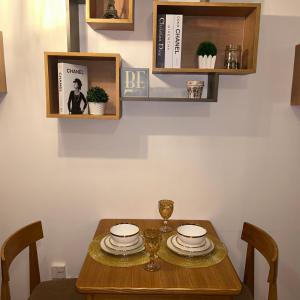 a dining room table with plates and glasses on it at AZURE URBAN RESIDENCES PARAÑAQUE by M&D Maui Tower in Manila