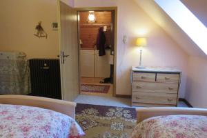 a bedroom with two beds and a dresser with a mirror at Ferienwohnung am Technikmuseum in Dessau +19 photos