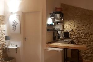a bathroom with a sink and a stone wall at Cabañita en Playa Caolin in O Vicedo +36 photos