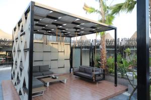 een paviljoen met een bank en een tafel op een patio bij Taj Al-Wajh Hotel in Al Wajh
