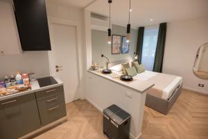 a kitchen with a bed and a counter in a room at Monte 21 - San Giusto in Trieste