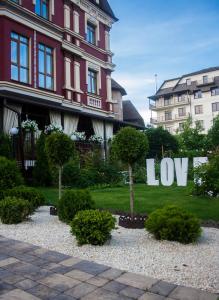 a garden area with a tree and a building at Hotel Lavilia in Kyiv