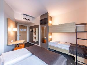 Postel nebo postele na pokoji v ubytování B&B Hotel Augsburg-Nord