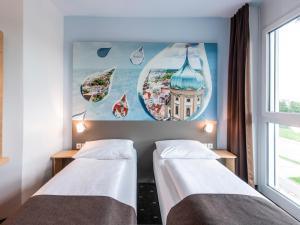 Postel nebo postele na pokoji v ubytování B&B Hotel Augsburg-Nord + 16 fotografií