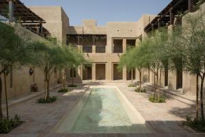 an external view of a building with a swimming pool at Bab Al Shams, A Rare Finds Desert Resort, Dubai in Dubai