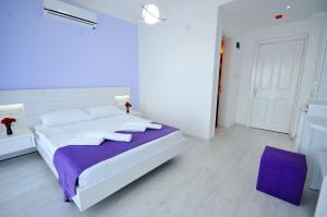 A bed or beds in a room at Fuda Hotel