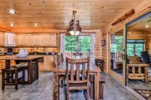 a kitchen with a wooden table and chairs in a cabin at Woodland Wonderland in Winchester