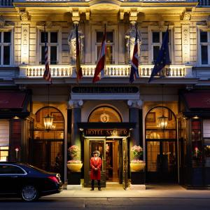 a man standing in front of a hotel exterior at Hotel Sacher Wien in Vienna