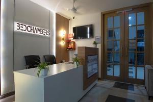 an office with a reception desk and a sign that reads bamboos at BedChambers Serviced Apartment, Medicity in Gurgaon