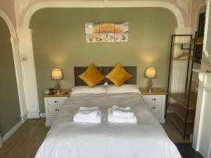 a bedroom with a white bed with two pillows at Walpole House in London