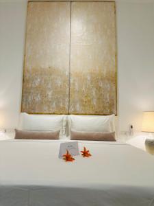 a bedroom with a bed with two starfish on it at Saffron Robes Living in Hikkaduwa