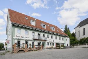 a large white building with a red roof at Zum Spitzbuam in Attenkirchen